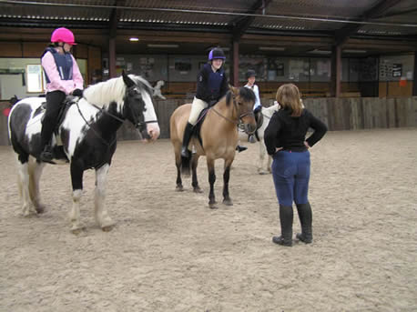 Instructor and student on horses